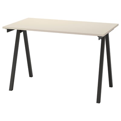 A TROTTEN desk with a beige top and black metal a-frame legs. The design is space-efficient and modern.