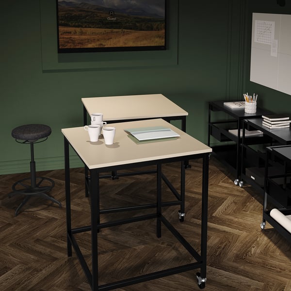 Modern office: two tables, cups, notebook, stool, green walls, wood floor.