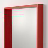 Red-framed mirror with visible wood grain, modern design, and safety film for protection.
