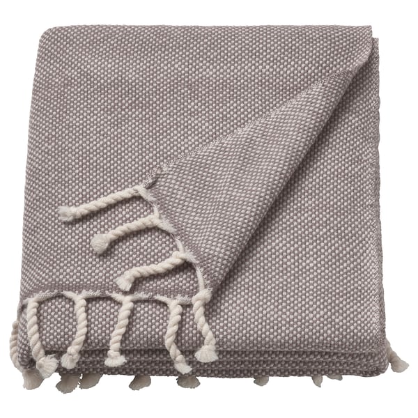 A grey wool throw blanket with fringe edges, soft and warm.