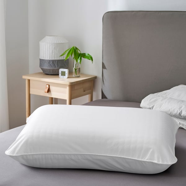 White ULLVIDE pillowcase on bed, soft cotton-lyocell blend.