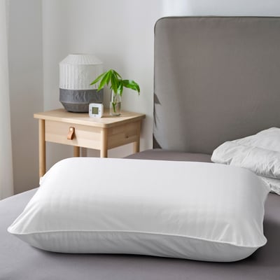 White ULLVIDE pillowcase on bed, soft cotton-lyocell blend.