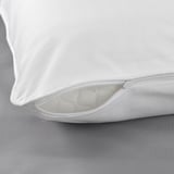 Close-up of soft, white pillowcase with smooth fabric and visible zipper, showcasing quality stitching and design.