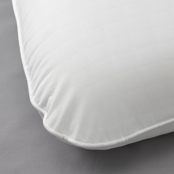 Close-up of smooth, white pillowcase with tight stitching, showcasing high-quality fabric.