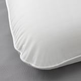 Close-up of smooth, white pillowcase with tight stitching, showcasing high-quality fabric.