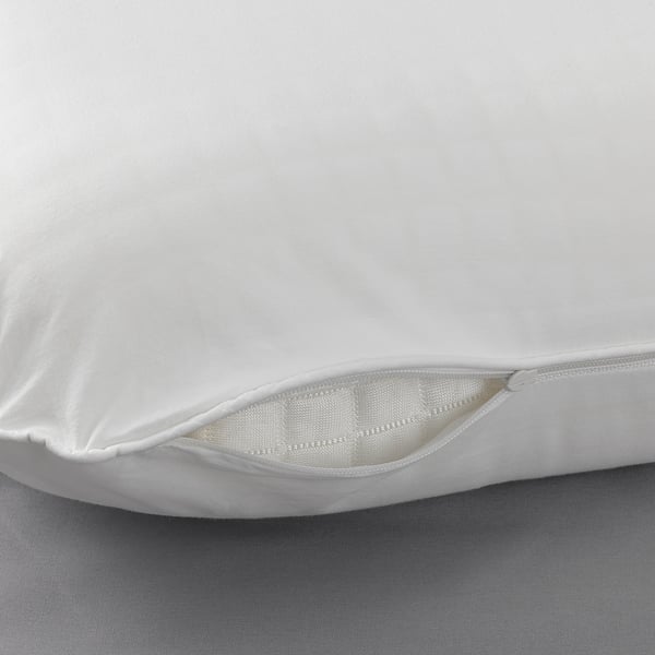 Close-up of smooth, high-quality white pillowcase showing fine weave and neat stitching.