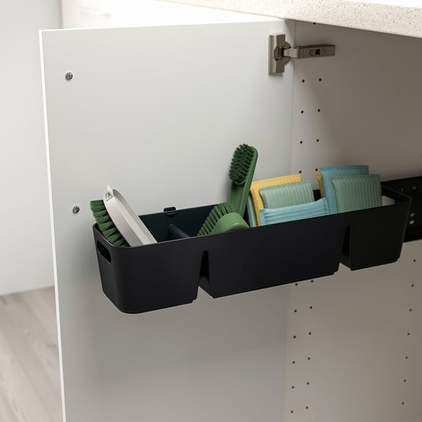 Black cabinet organizer holds cleaning tools, mounted inside cabinet, enhances storage.