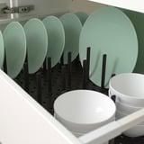 Kitchen drawer organizer with adjustable pegs for plates, bowls, and lids.