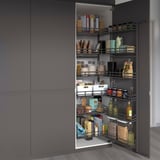 Open pantry with gray baskets showing organized food items, easy to access.