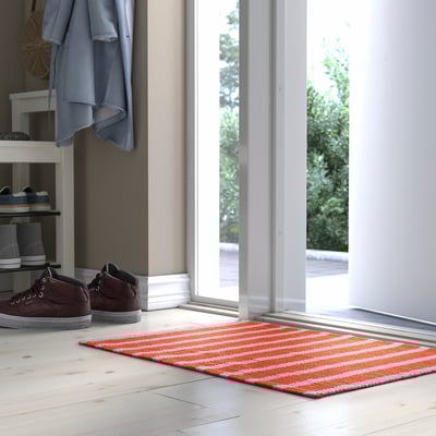 Orange & white striped door mat near entrance.