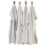 Four striped towels hang neatly, white with blue lines, each with frayed edges.