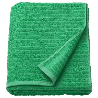 Bright green VÅGSJÖN towel, folded neatly, showcasing soft, textured terry cloth, pure cotton material.