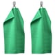 Two green VÅGSJÖN towels hang on silver hooks, bright and absorbent, with a ribbed texture and medium thickness, made of 100% cotton.