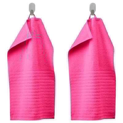 Bright pink VÅGSJÖN towels hang side by side on hangers, soft, absorbent, textured.