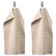 Option: Two beige VÅGSJÖN towels hang side-by-side, featuring textured stripes and solid terry sections, suspended from silver hooks.