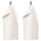 Two white VÅGSJÖN towels hang on silver hooks, texture visible.