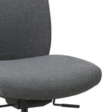 Close-up of ergonomic VALLFJÄLLET office chair, showing plush, dark grey fabric seat and backrest. High-quality density foam for comfort.