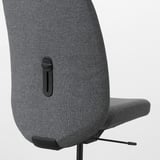 Close-up of ergonomic office chairs back and seat, showing high-quality fabric and durable design.