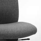 Close-up of a modern, ergonomic office chairs cushion and backrest in gray fabric. Highlights the soft, supportive seat and backrest materials.