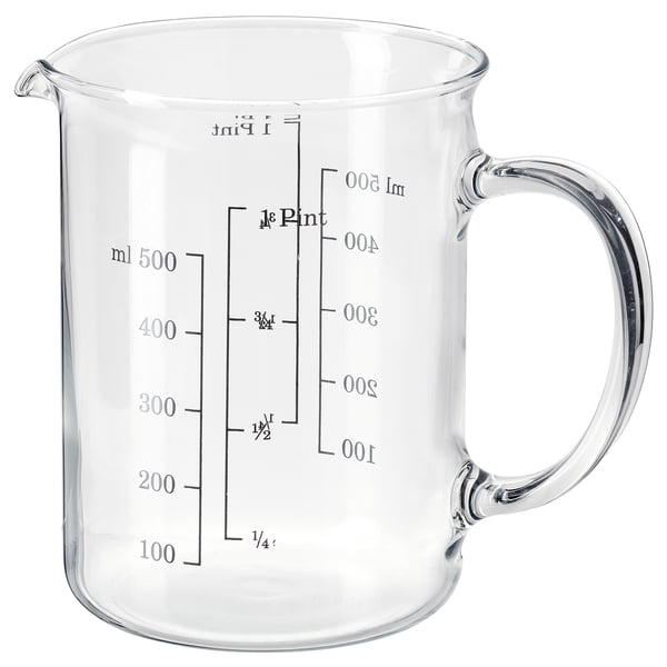 Clear glass measuring jug with handle, marked in milliliters and cups, transparent, simple design, ideal for kitchen use.