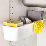 A VARIERA storage container holding yellow sponges, a scrub brush, and yellow gloves, neatly organized for easy access.
