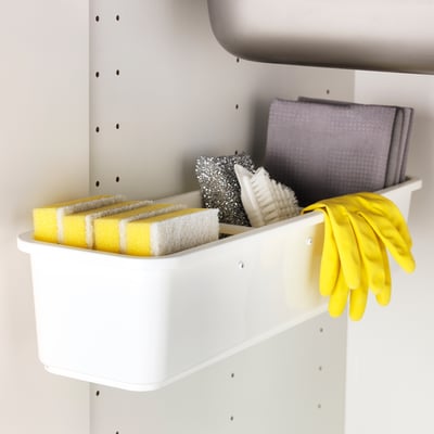 A VARIERA storage container holding yellow sponges, a scrub brush, and yellow gloves, neatly organized for easy access.