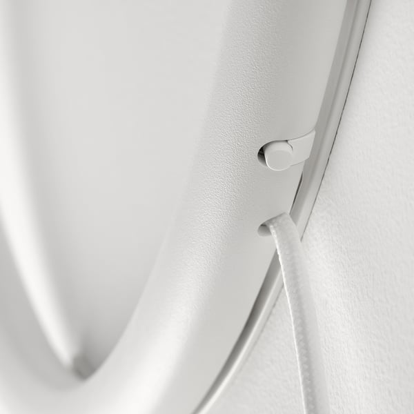 Close-up of modern white wall lamps switch, showcasing sleek design and quality materials.