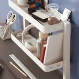 Desk organizer with headphones, water bottle, books, sand timer, scissors, utensils.