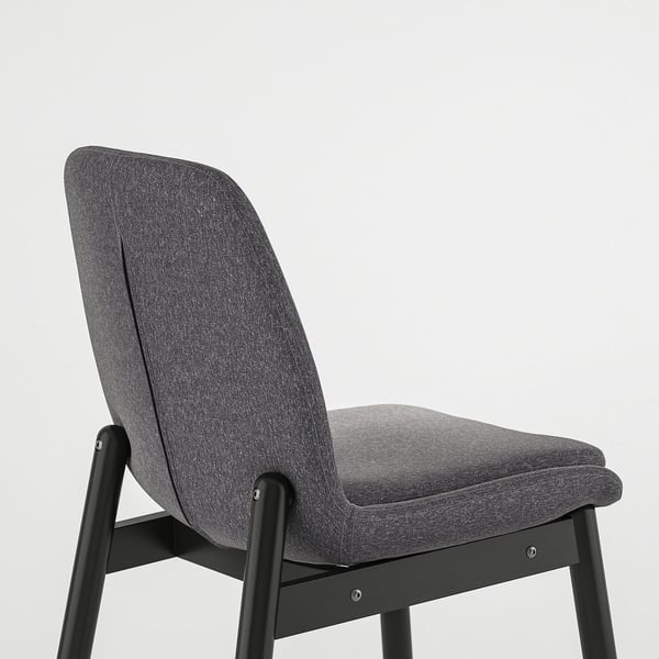 Modern high-back chair with dark grey fabric and black metal frame.
