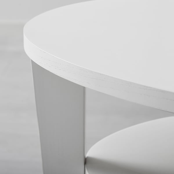 A sleek, modern table with a smooth, round, white top and curved legs, showcasing quality design.
