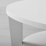 A sleek, modern table with a smooth, round, white top and curved legs, showcasing quality design.