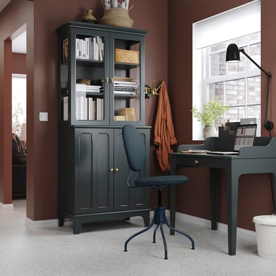 Home office with VIELÅNGEN desk & cabinet, laptop, lamp, blue chair, neat books, natural light, cosy wall blanket.