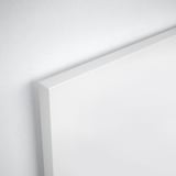 Crisp white corner of a sleek, modern bed frame, showcasing clean lines and smooth finish.