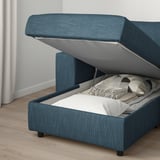 Blue upholstered sofa with storage. Lid lifts up to reveal blankets inside.