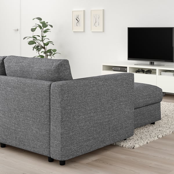 Modern living room with gray VIMLE sectional sofa, flat-screen tv, wall art, and plant.