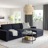 VIMLE modern black sofa, l-shaped with storage, fits well in spacious living rooms, accented by woven pendant lamp, grey curtains, and white rug.