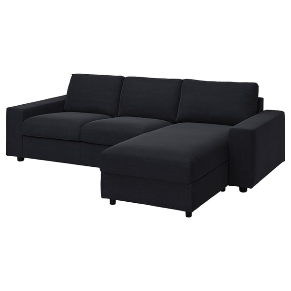 Black l-shaped sofa with sectional chaise, modern design, dark grey upholstery, clean lines, supportive cushions.