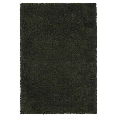 A VINDEBÄK rug in green. It a two-tone mélange design and is made from 100% polyester. The rug is square-shaped and has a soft, high-pile surface.