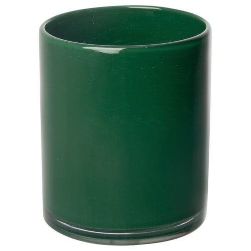 Green glass candlestick, mouth-blown, cylindrical shape with decorative paint pattern, sits on flat base.