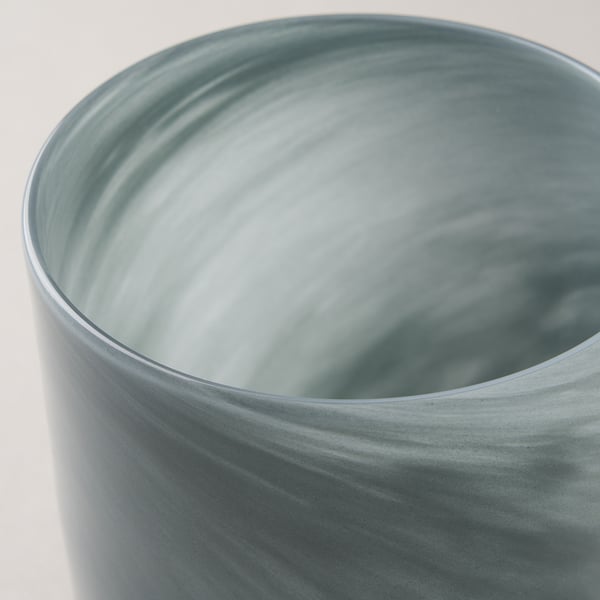 Glass candle holder with blurred swirl pattern, smooth edges, and glossy finish.