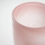 Pink glass candle holder, smooth edges, handcrafted quality, gently glowing.