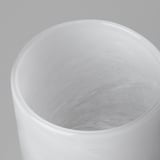 Cylindrical glass vase with smooth, glossy finish. Intricate, swirling pattern inside, reflecting quality craftsmanship.