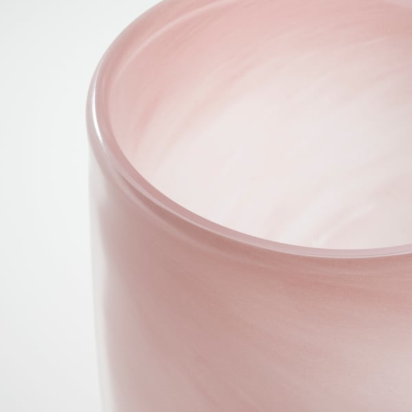 Frosted pink glass tealight holder, handcrafted with smooth edges, reflecting light softly.