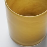 Gold-colored, polished glass candle holder with smooth surface, viewed from above.