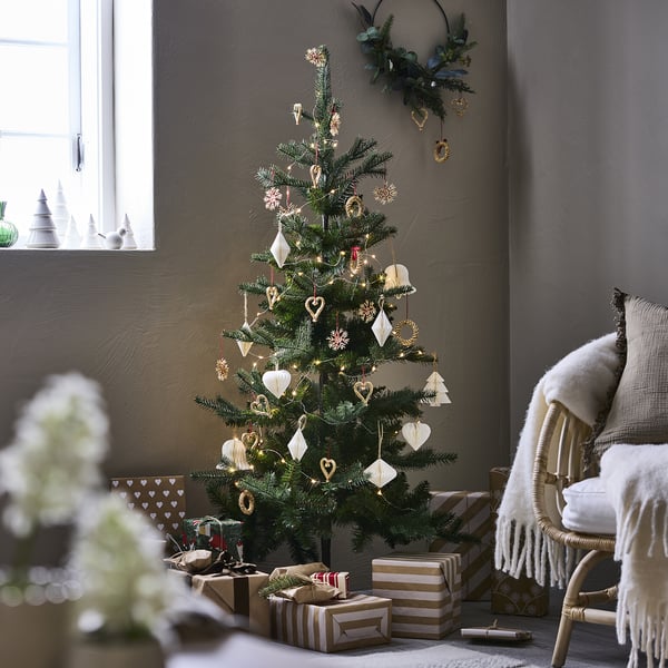VINTERFINT christmas tree with white ornaments & lights near window.