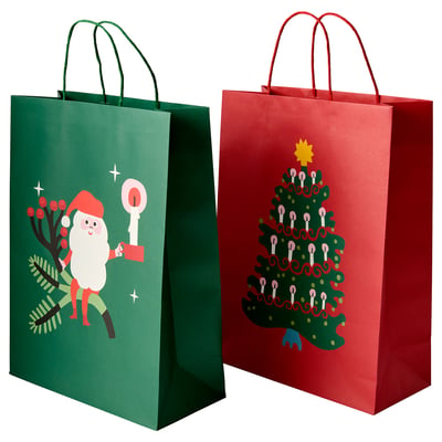 Two holiday gift bags: one green with santa, one red with a christmas tree.