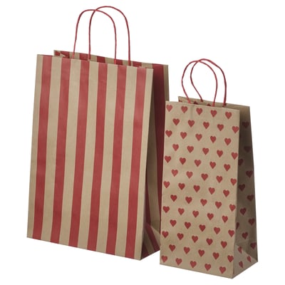 Two brown paper bags, one striped red, one with red hearts, both with red handles.