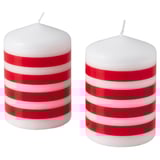 Two red and white striped candles, standing upright, cylindrical shape, cotton wicks, made of paraffin and plant-based wax.