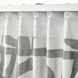 Black and white patterned curtains hang with hooks, providing privacy and style.