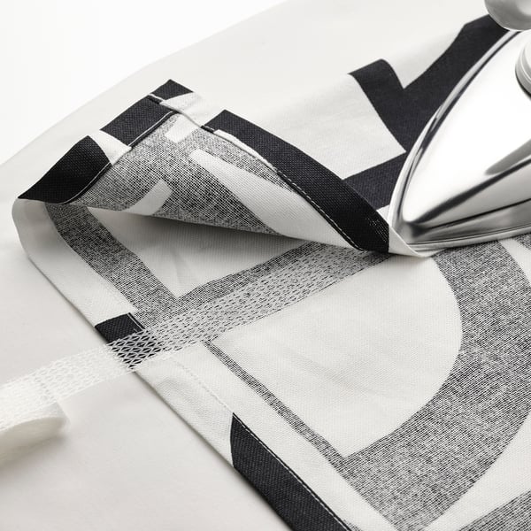 Black and white patterned curtains folded, iron on top. Curtains from VINTEROXBÄR collection.